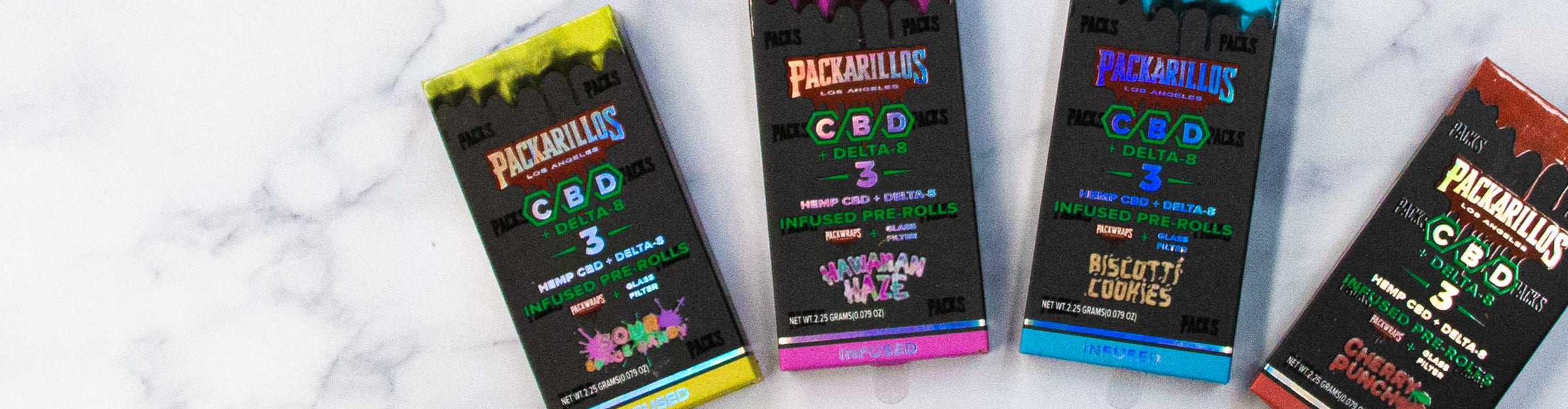 Packarillos CBD products laying down on white marble textured background