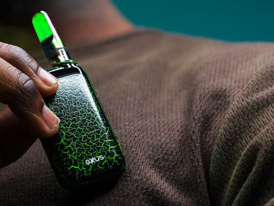 Man holding Exxus Rizo Crackle in front of teal studio background