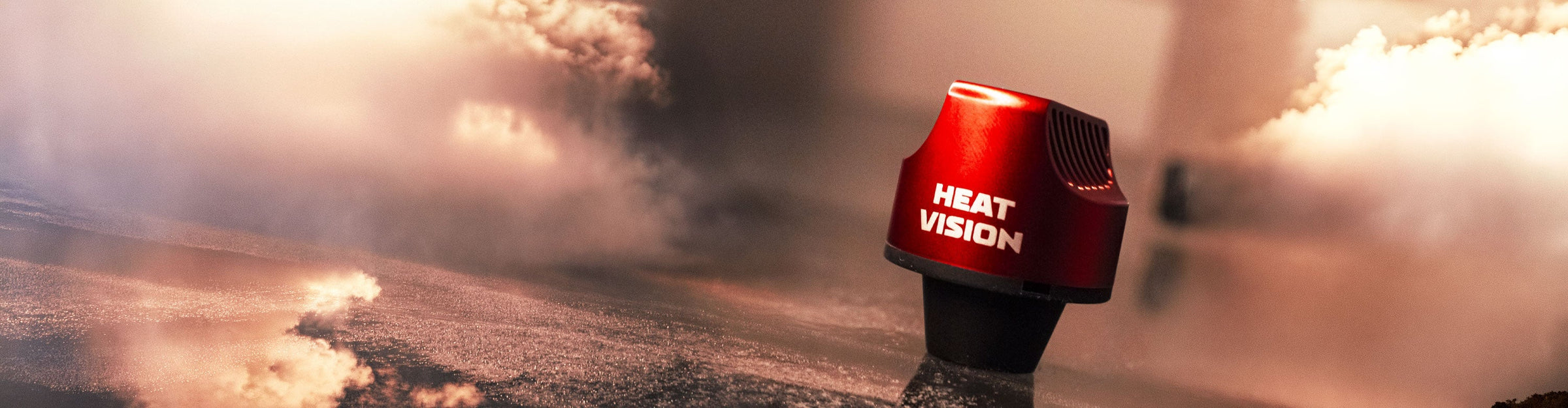Yocan Heat Vision standing on dark surface with smoke clouds nearby