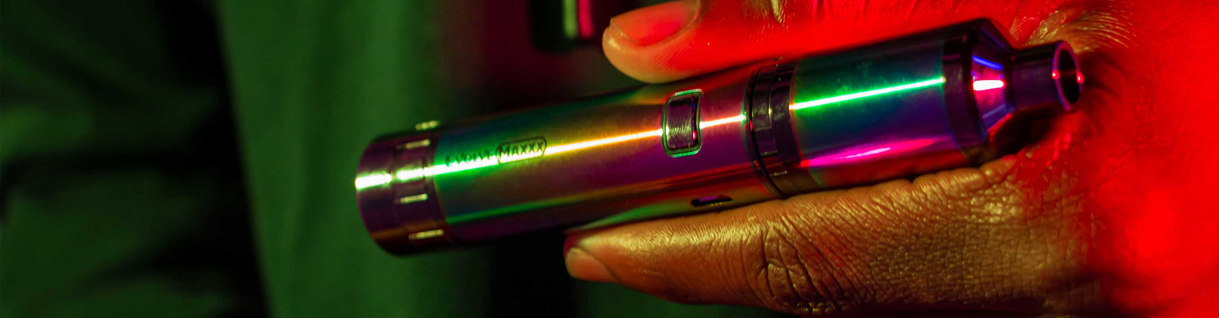 Man with jacket holding the Wulf Evolve Maxxx inside studio with red lighting