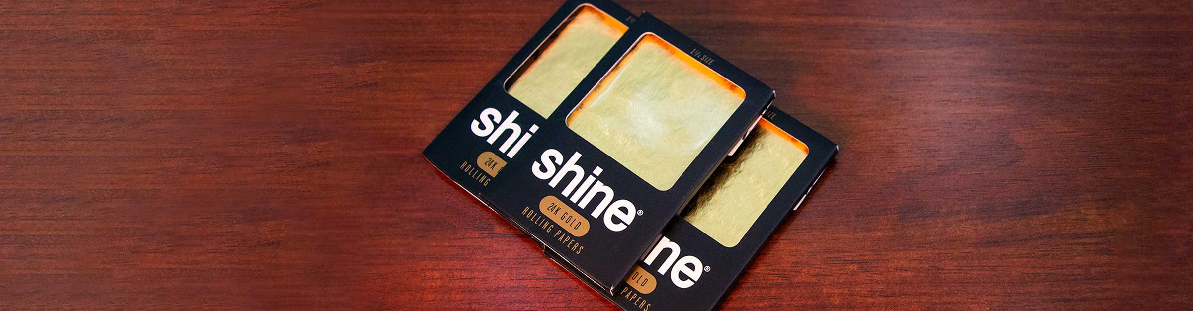 Shine Gold Wraps laying down on wooden table inside office building.