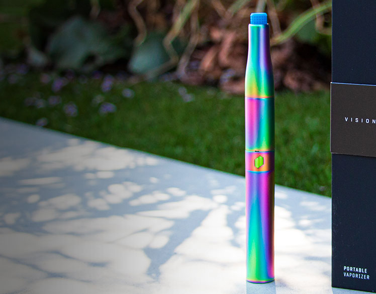 Puffco Plus Vision Edition standing outside on wall near parking lot