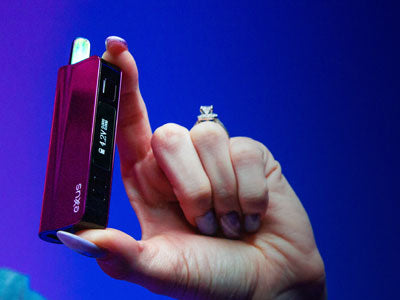 Exxus Snap VV Pro in woman's hands in front of blue studio background