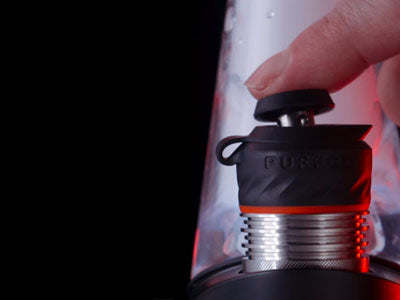 man controlling the puffco peak 3dxl chamber in black background