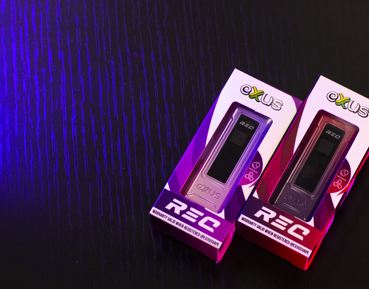 Exxus RECs resting in packaging underneath soft purple lighting