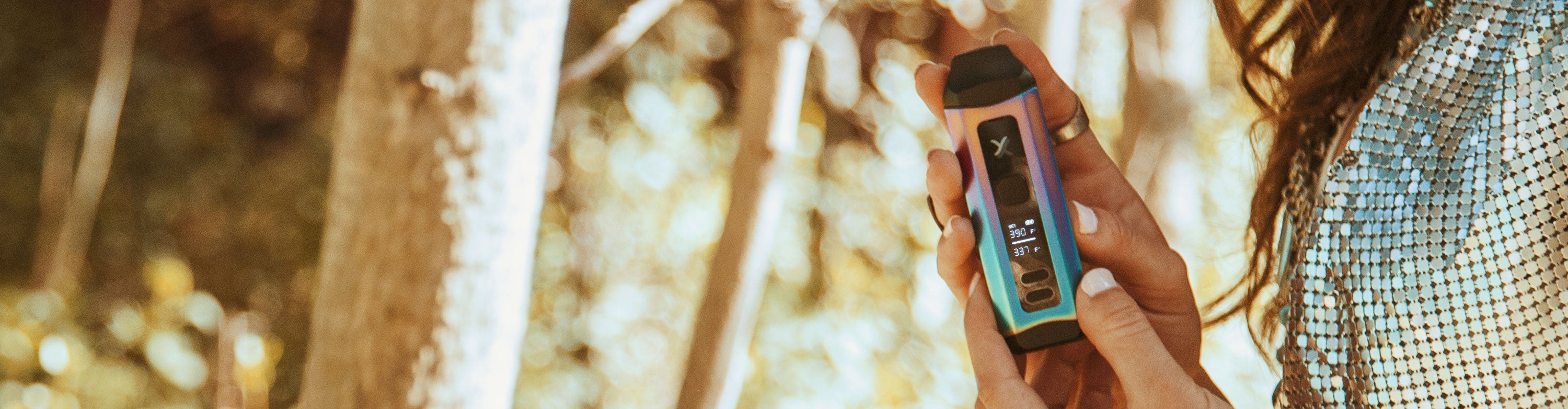 Woman holding Exxus Mini Plus in a forest