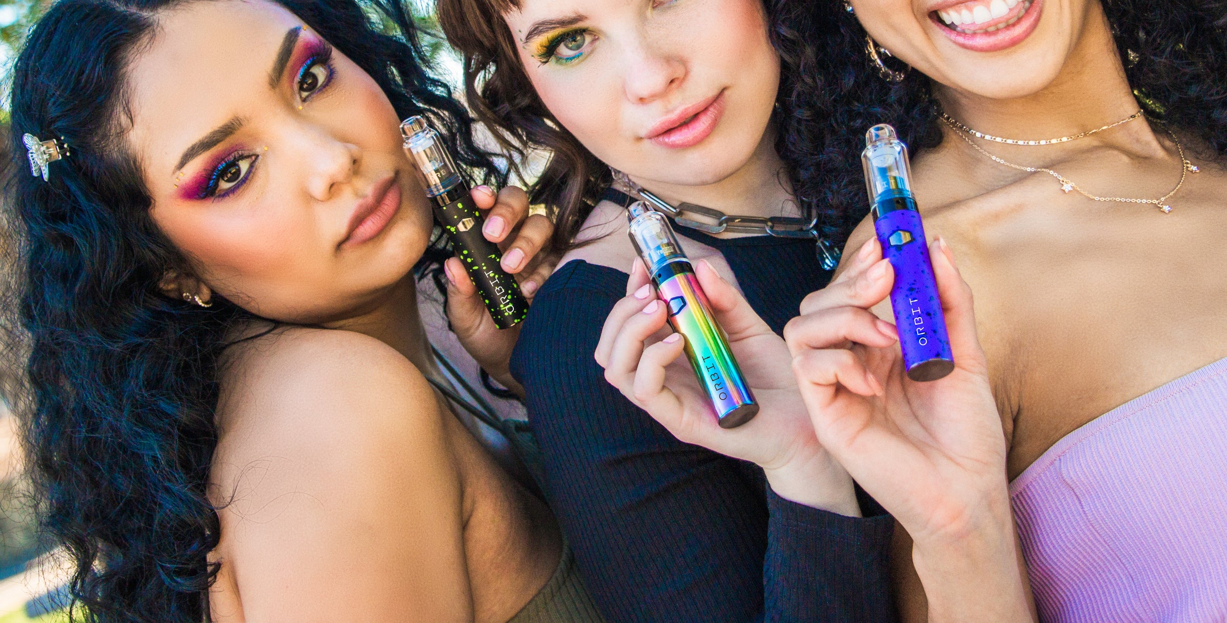 Three women holding Wulf Orbits at a park