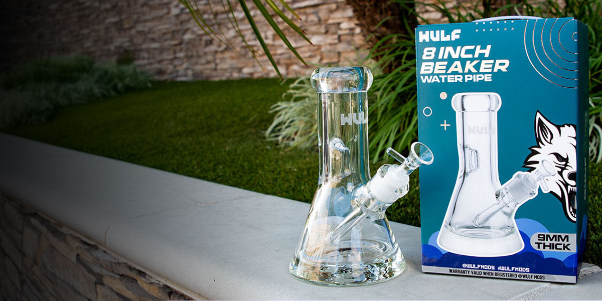 Glass water pipe with packaging on a table outdoors