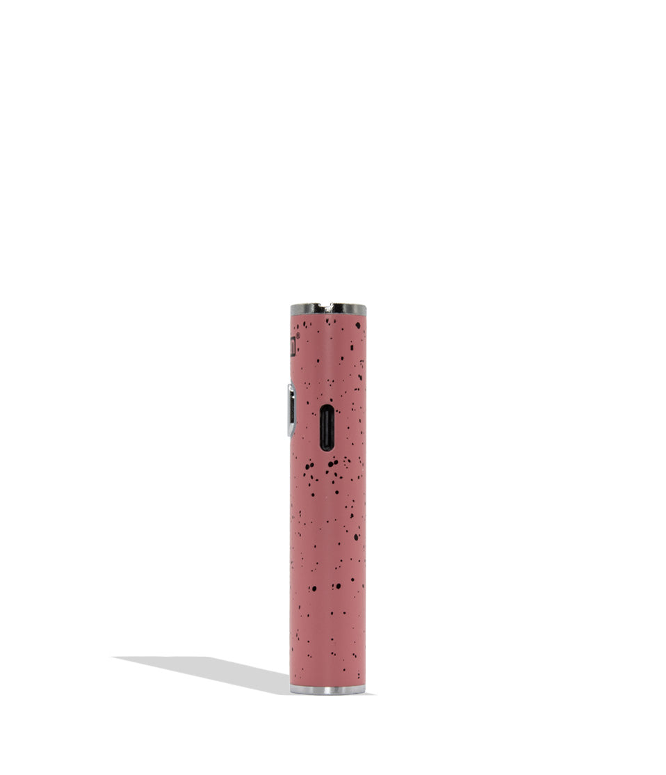 A pink cylindrical vape device with a black speckled pattern and silver metal accents, standing vertically on a white background with a soft shadow.