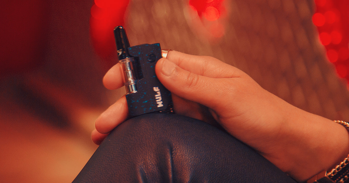 Girl holding black with blue spatter Wulf Micro Plus