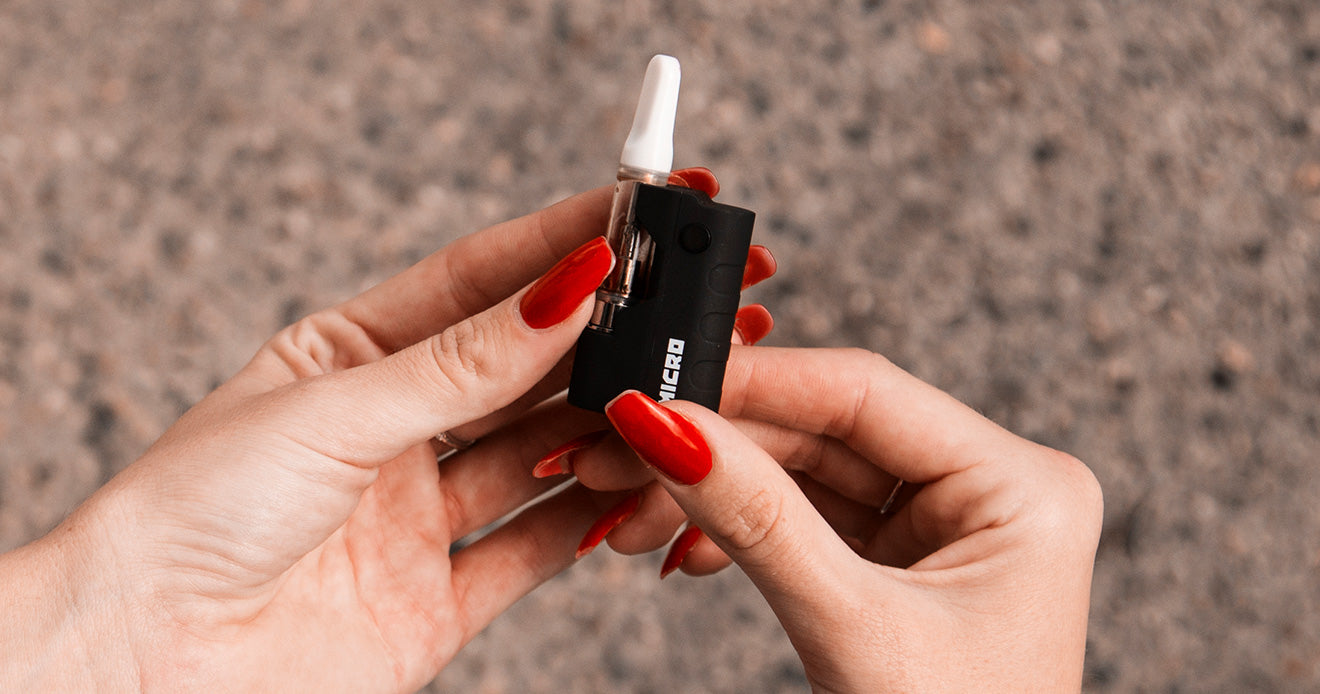 Woman holding a black Wulf Micro
