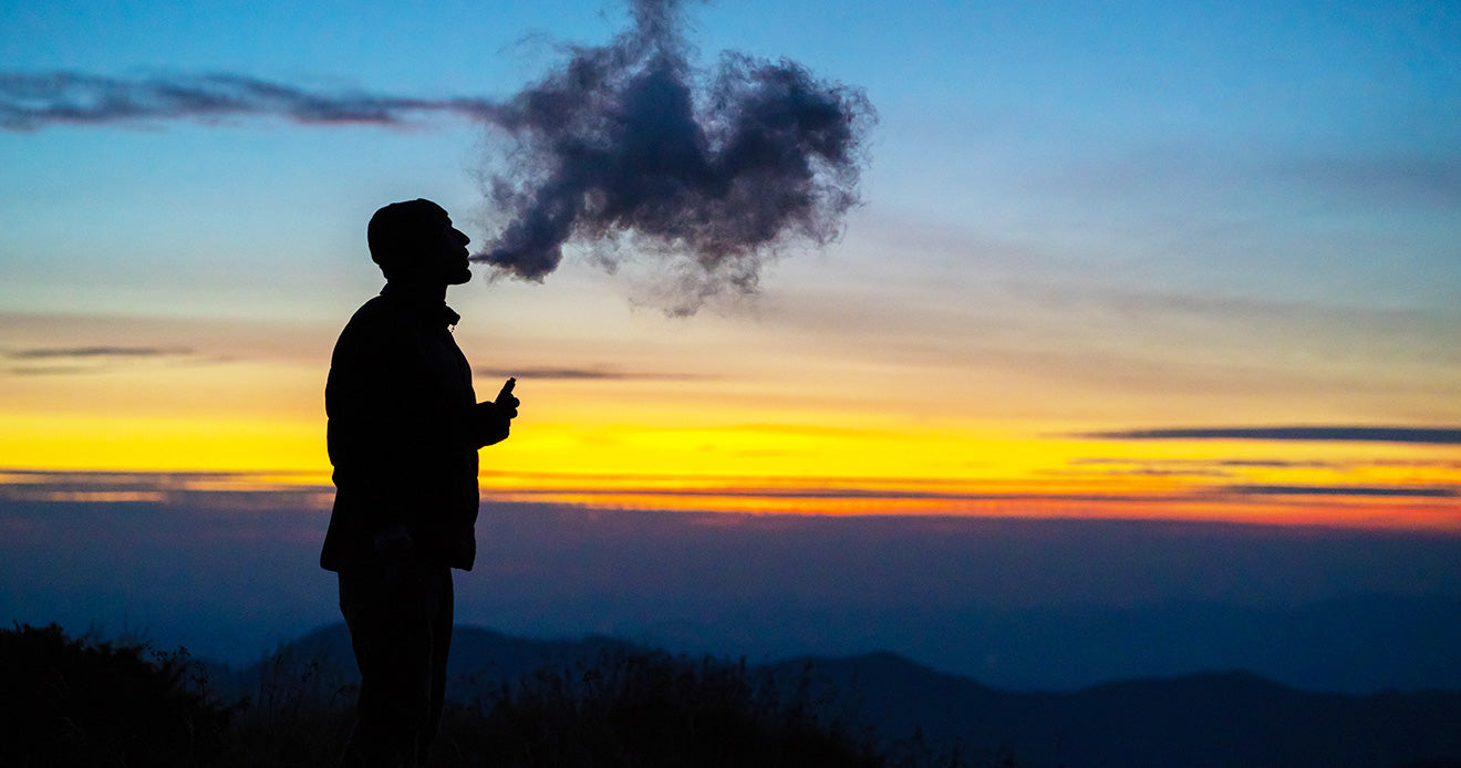 Vaping man on a mountain