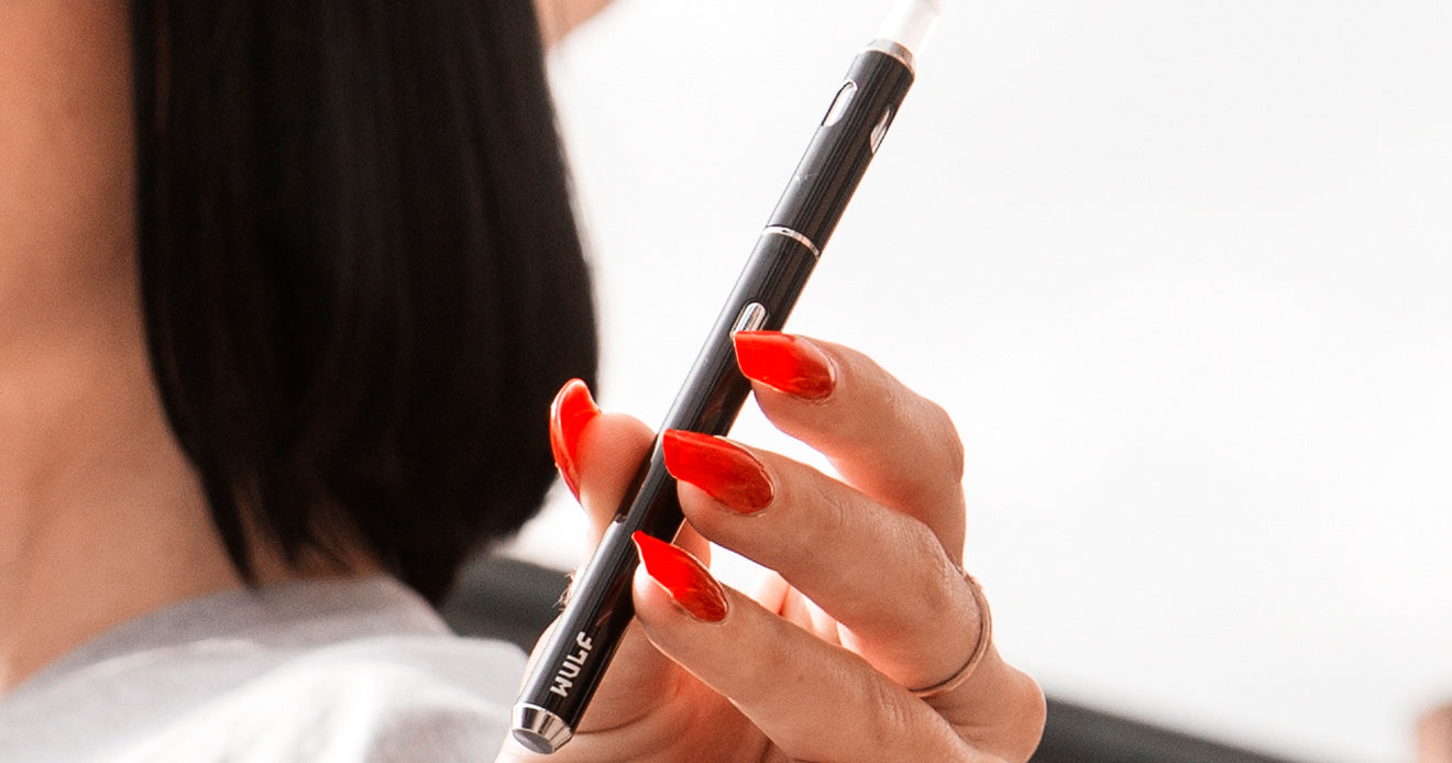 Girl with red nails holds SLK Vape Pen