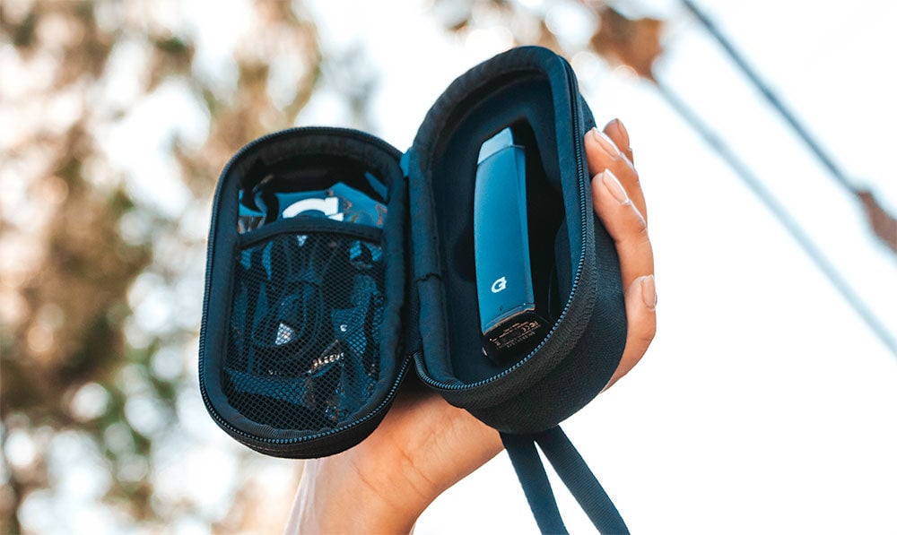 Hands holding a GVR dry herb vaporizer in its case