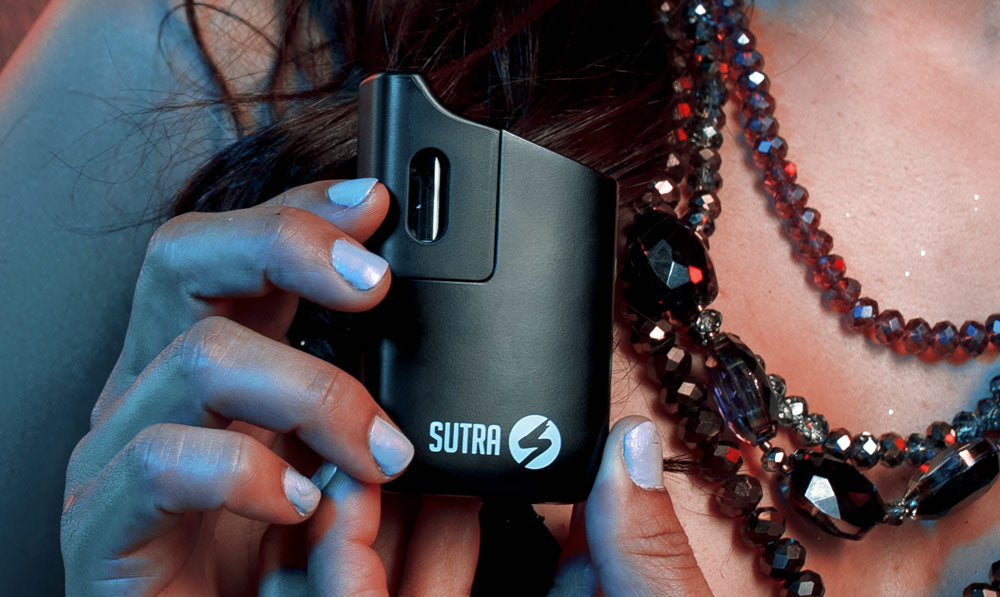 Sutra mini in woman's hands with cool lighting