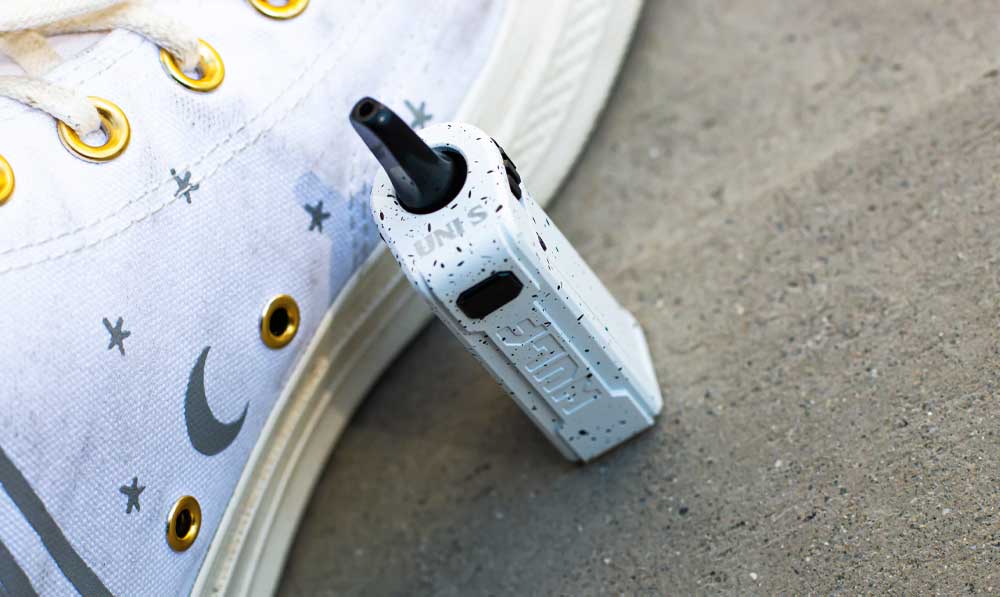 White and Black Spatter Wulf UNI S standing near white shoe outside