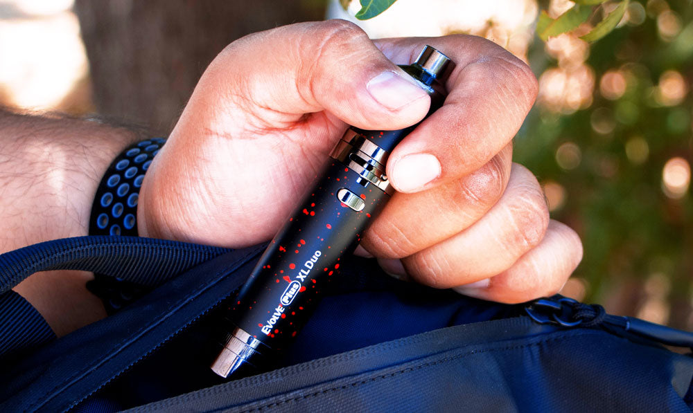 Wulf Mods Evolve Plus XL Duo in man's hands in front of trees