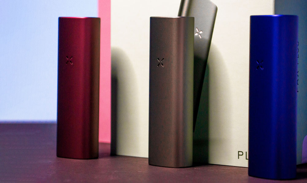 PAX Plus collection standing on dark table in front of light studio background
