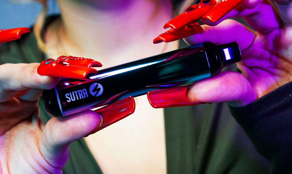 Sutra silo in woman's hands with red nails