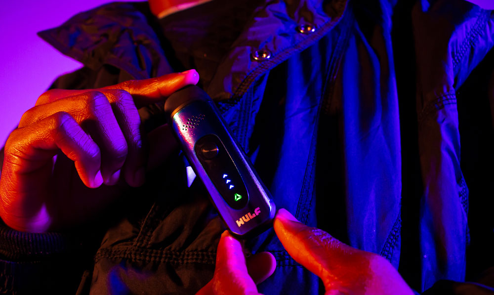 Wulf Next in man's hands with purple and red lighting