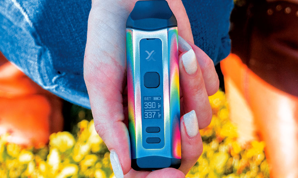 Exxus Mini Plus in woman's hand in a meadow
