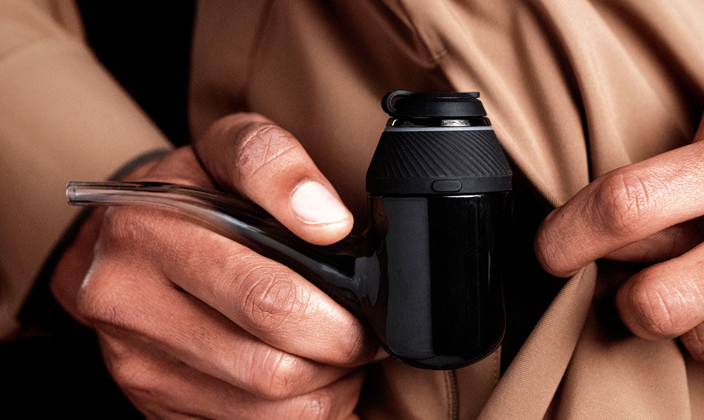 Puffco Proxy in man's hand about to be placed in a pocket