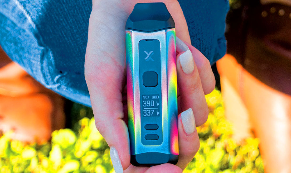 Woman holding Exxus Mini Plus in grass with natural spring lighting