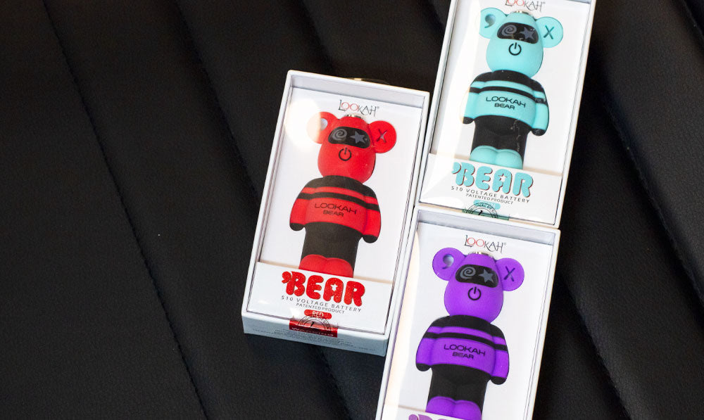 Lookah Bear 510 Thread Batteries resting on leather seat