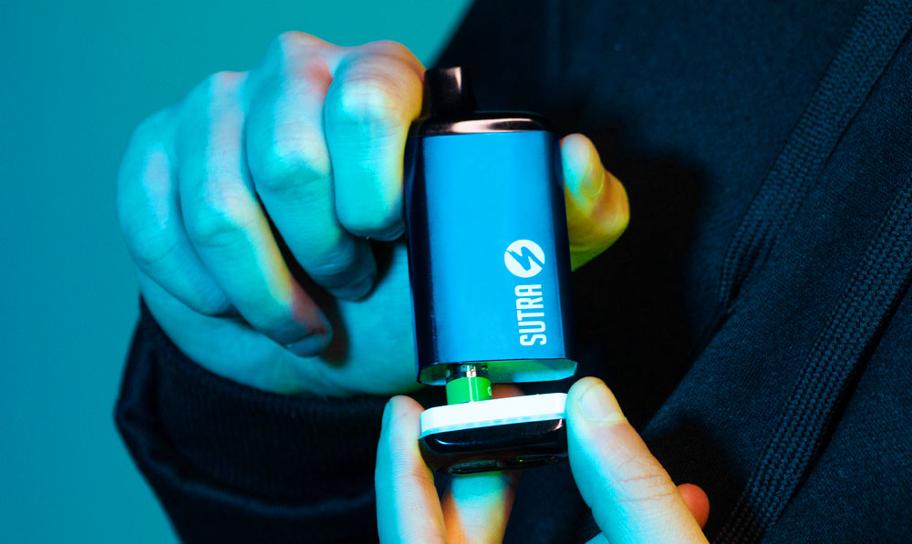 Man holding Sutra SILO Pro under soft blue studio lighting