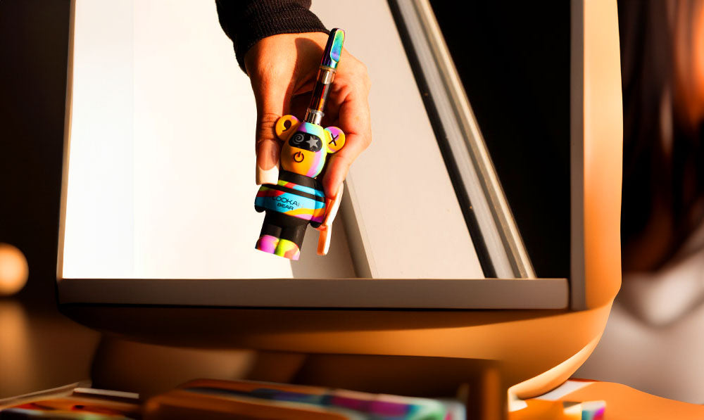 Woman in TV show holding Lookah Bear Limited edition over windowsill