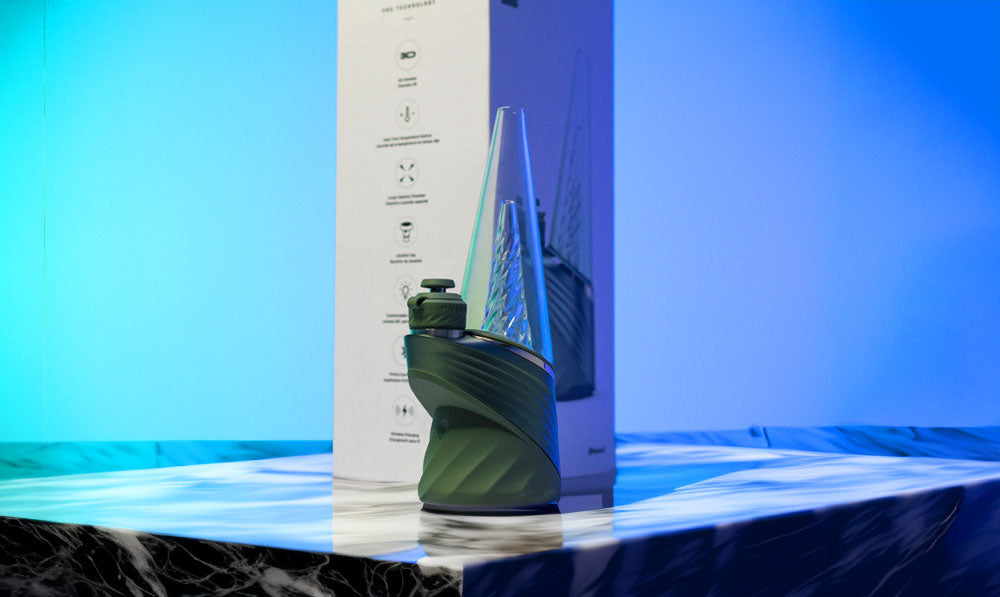 Puffco New Peak Pro Flourish standing on marble display in front of blue studio background
