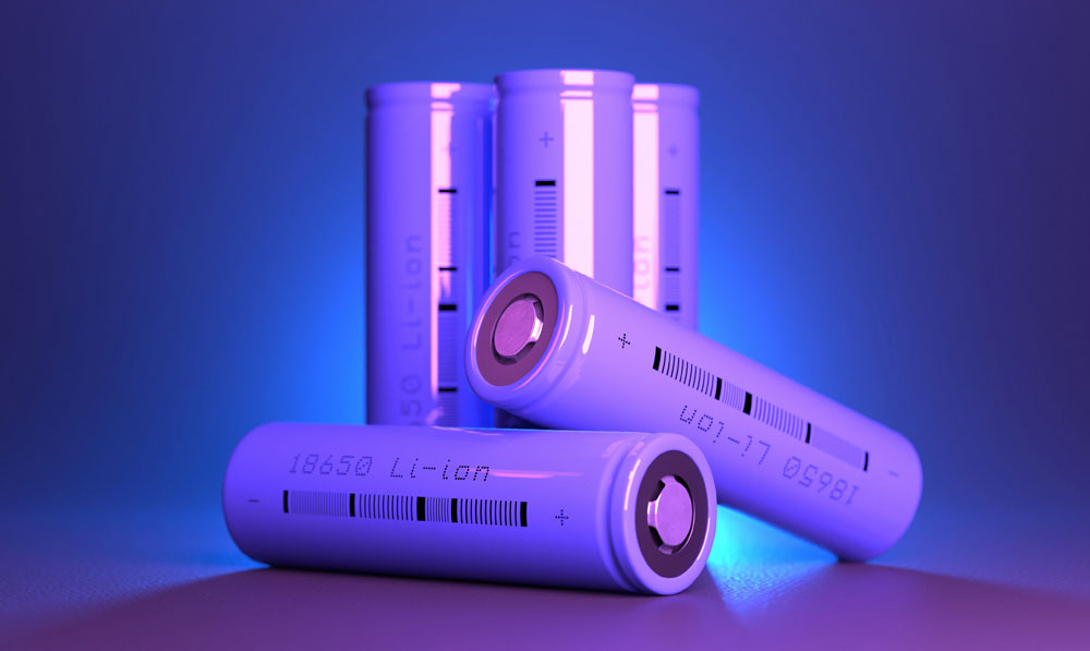 Lithium batteries resting on purple background stacked on top of each other