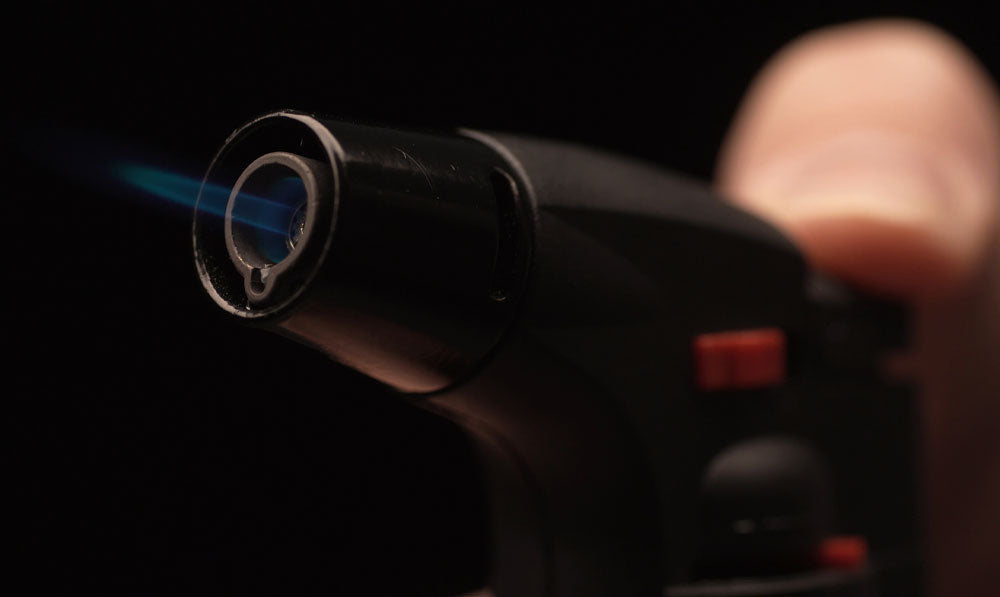 Closeup of person using butane torch