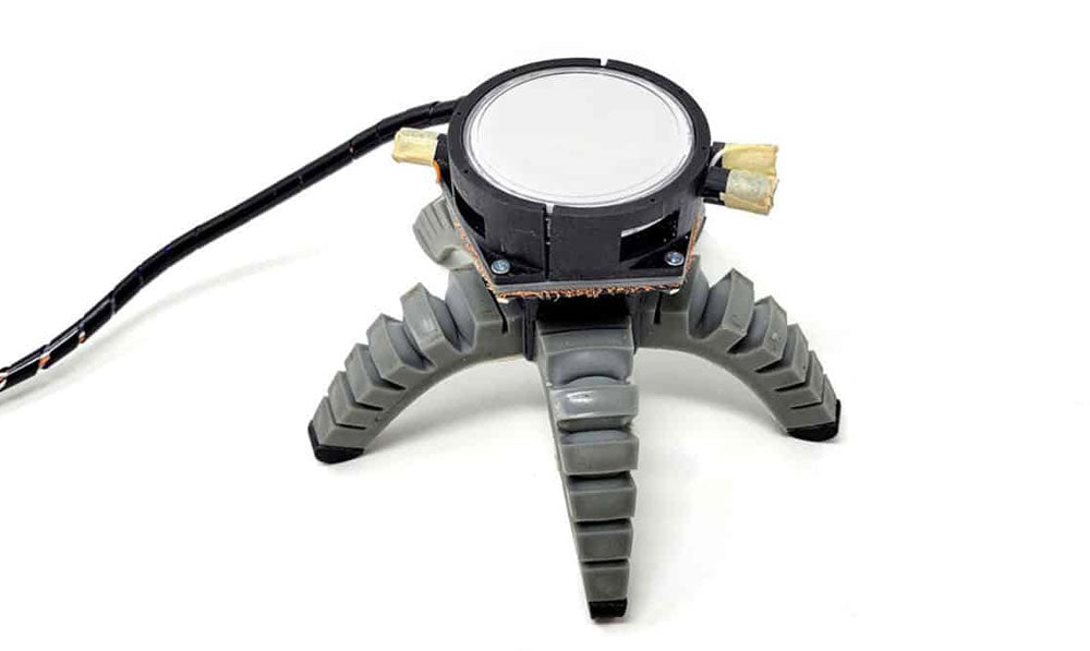 Mushroom attached to a robot body on white surface
