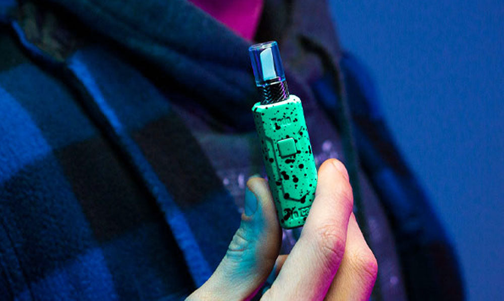 Man holding Wulf Kodo Knife in front of blue studio background