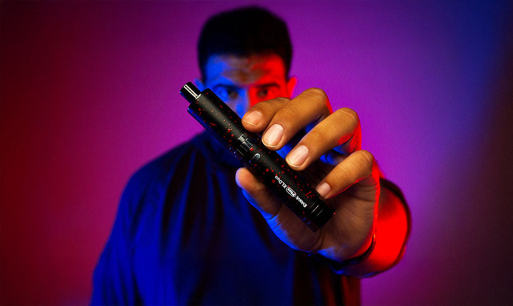 Man holding Wulf Evolve Plus XL Duo in front of red and purple background