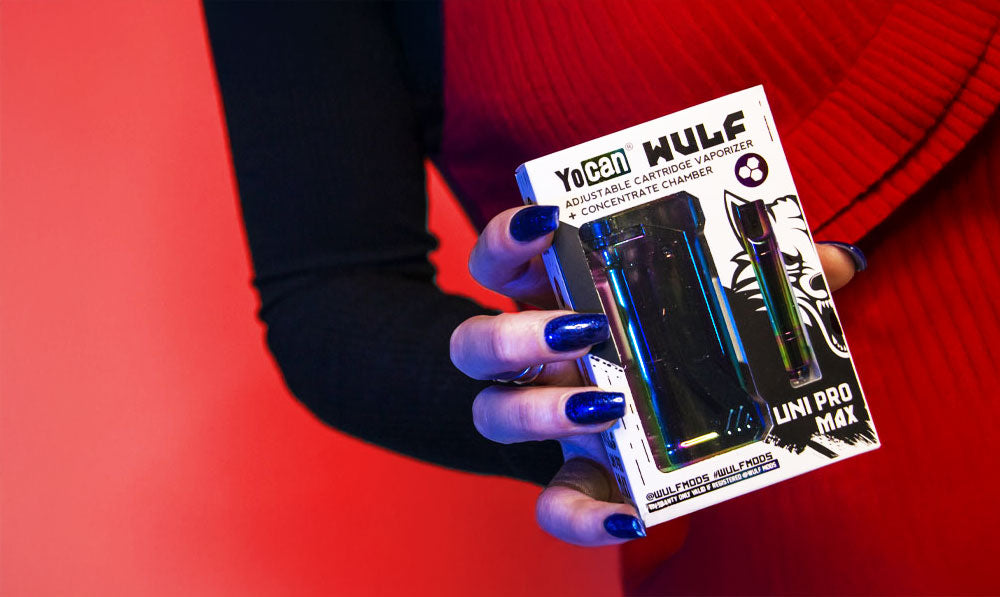 Woman holding Wulf UNI Pro max in front of red studio background