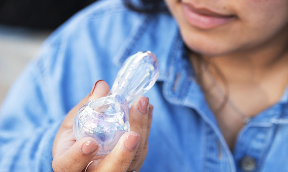 Woman holding Wulf Globe hand pipe at park