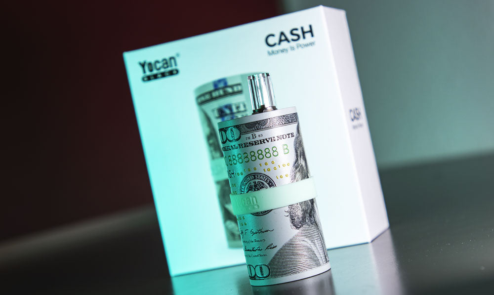 Yocan Cash standing on dark surface with green lighting