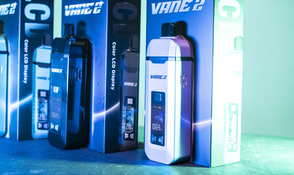 Yocan Vane 2 on dark surface with teal and blue studio lighting