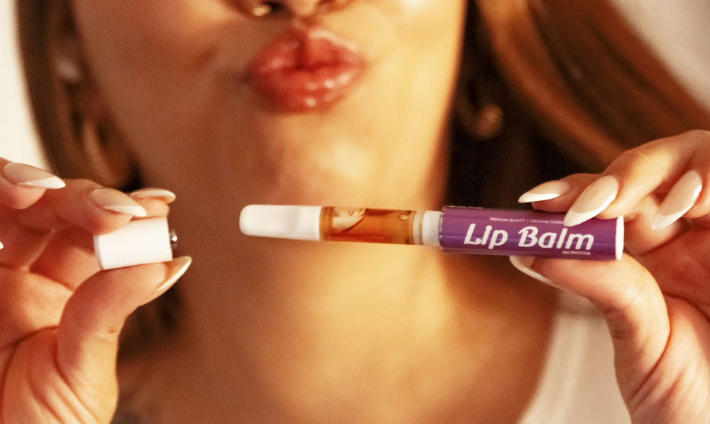 Woman holding Smyle Chapstick Battery apart