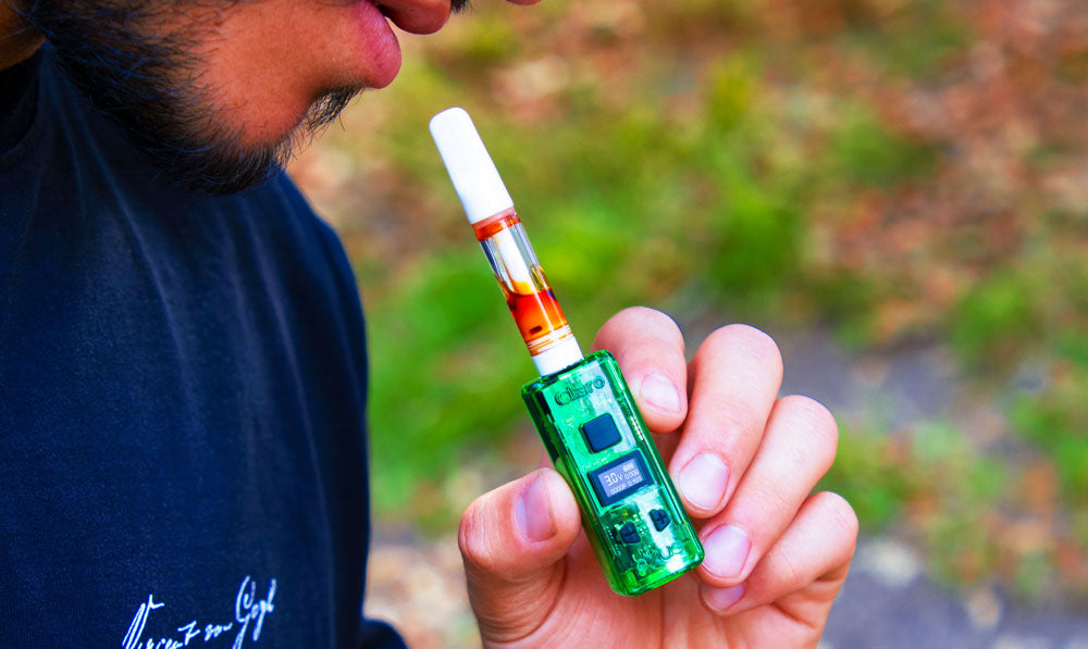 Man holding Exxus Claro on a park trail