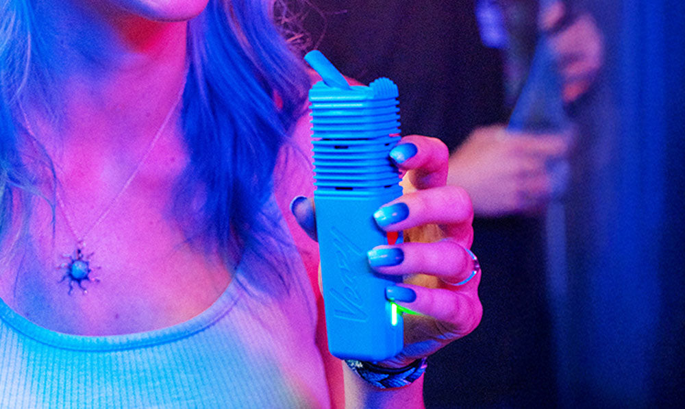Woman holding Storz & Bickel Veazy inside a club