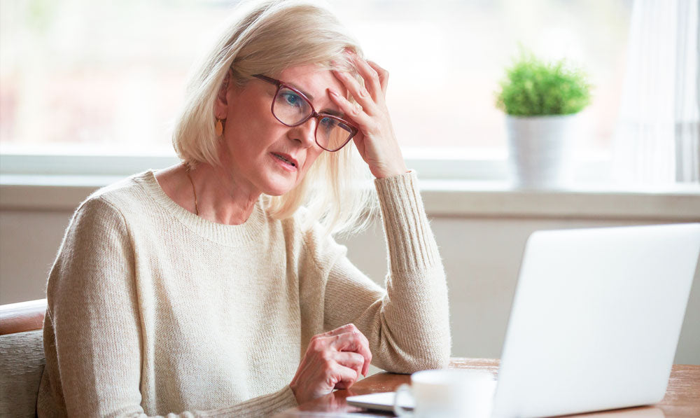 Person looking frustrated while staring at a laptop
