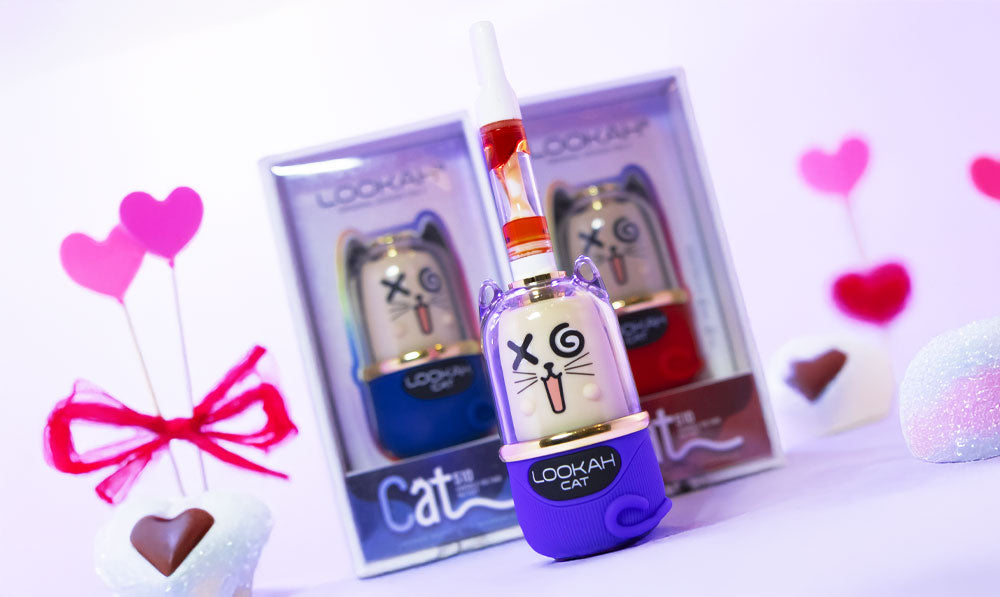 Lookah Cat on white surface with packaging and Valentine's Day chocolates nearby