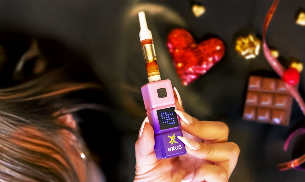 Woman holding Exxus Stax with chocolates nearby