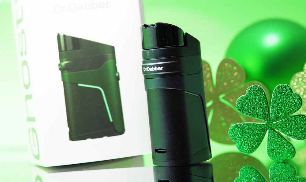 Dr. Dabber Ghost 2 on reflective surface with St. Patrick's Day decorations nearby