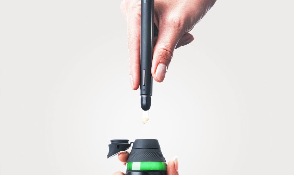 Hand dropping dab with Onyx Puffco New Hot Knife into Puffco Proxy Core