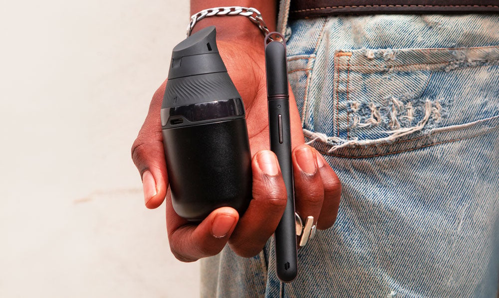 Woman in jeans holding Puffco New Hot Knife with Proxy Core