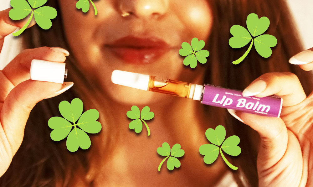 Woman holding Smyle Chapstick open with clovers falling nearby